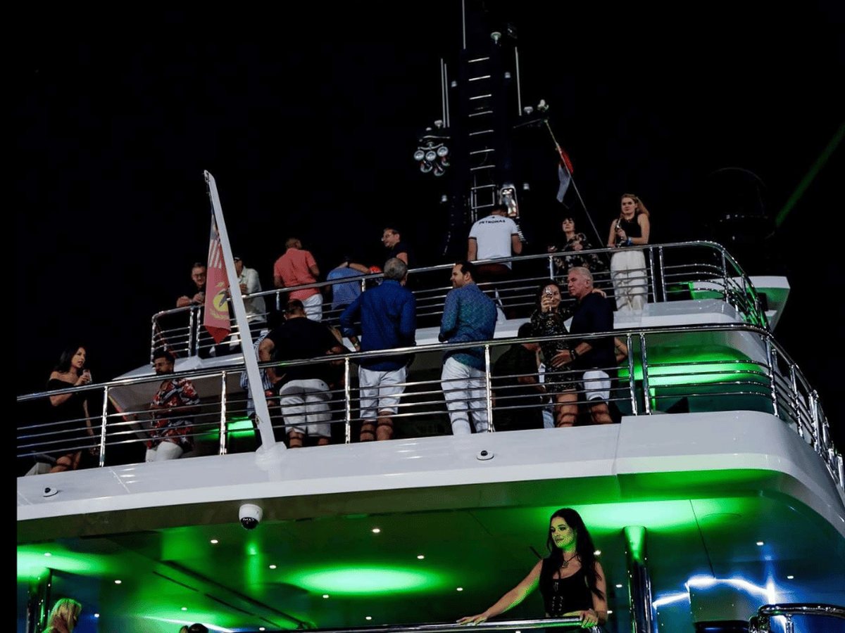 Guests on the decks of the superyacht during an evening party