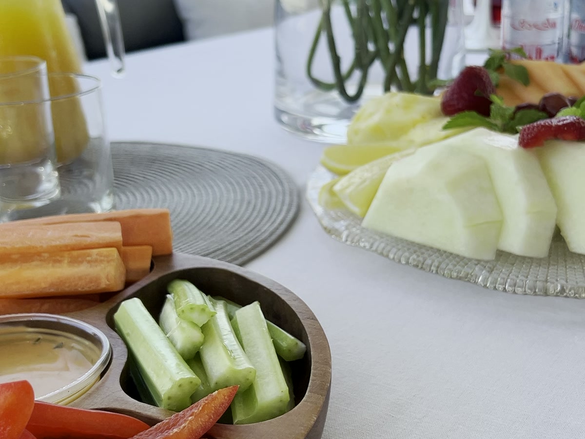 Fruit platter, chilled water and fresh juice laid out on a yacht table in Dubai Marina