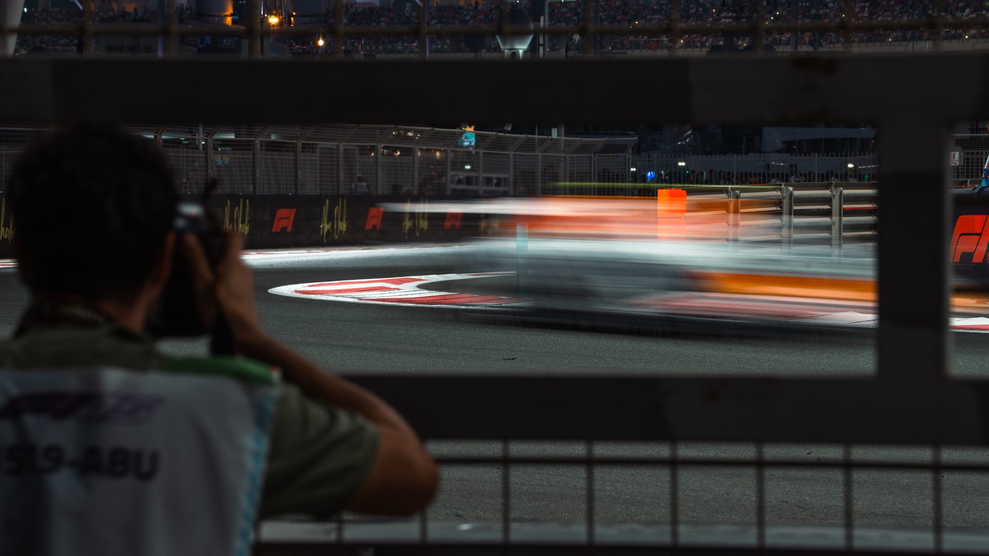 Photographer tracking a car through the barrier