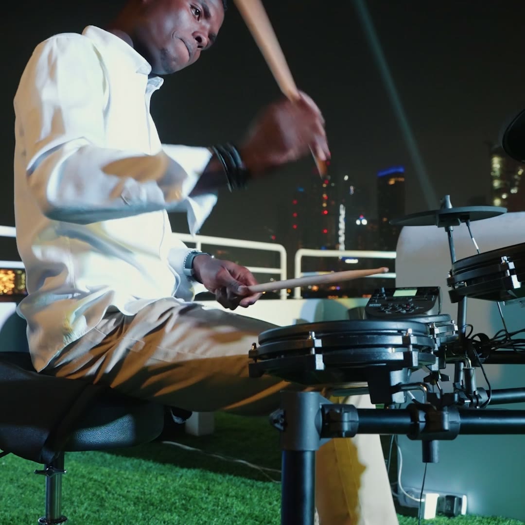 Drummer performing on the deck of an event yacht at night in Dubai