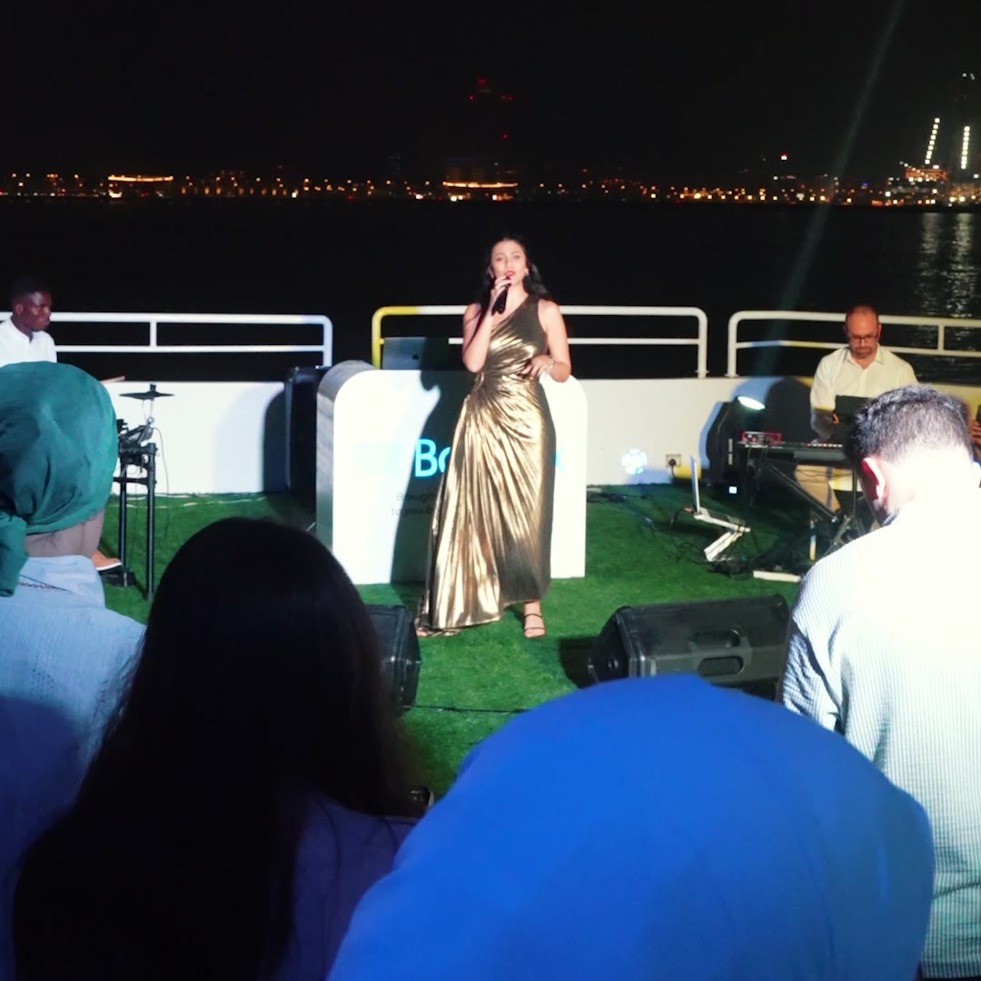 Live singer and keyboard player performing on the upper deck of a yacht during a corporate launch in Dubai